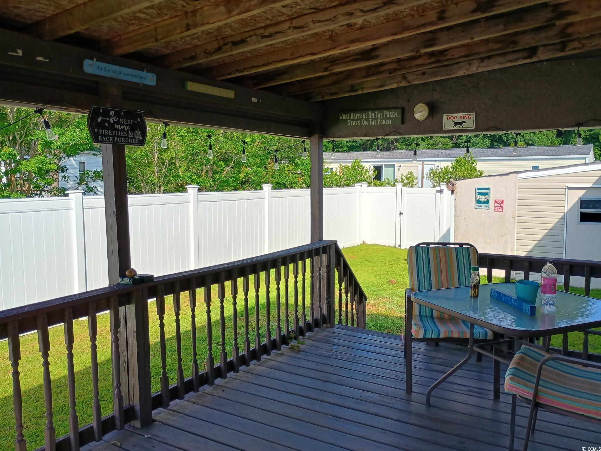 1049 Colonial Lane Conway, SC 29526 - Photo 20 of 27 Deck with outdoor dining area and a fenced backyard