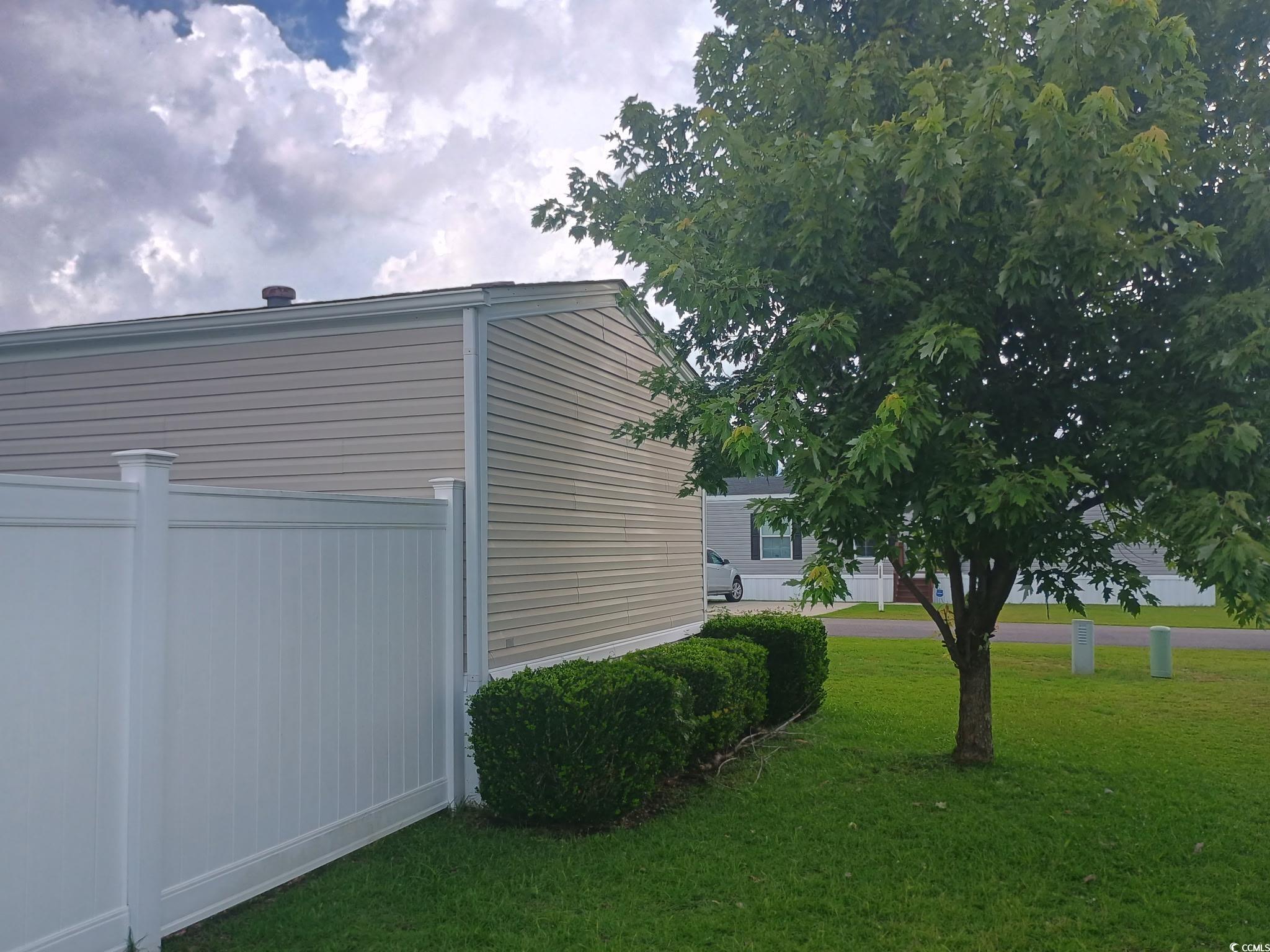 1049 Colonial Lane Conway, SC 29526 - Photo 23 of 27 View of home's exterior with a lawn