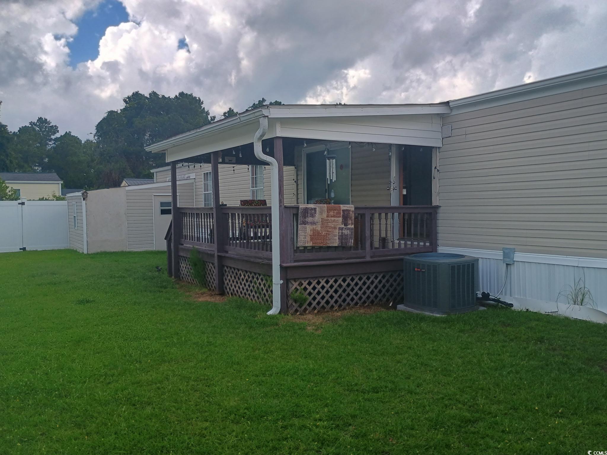 1049 Colonial Lane Conway, SC 29526 - Photo 3 of 27 View of home's exterior with a lawn, a deck, and a shed