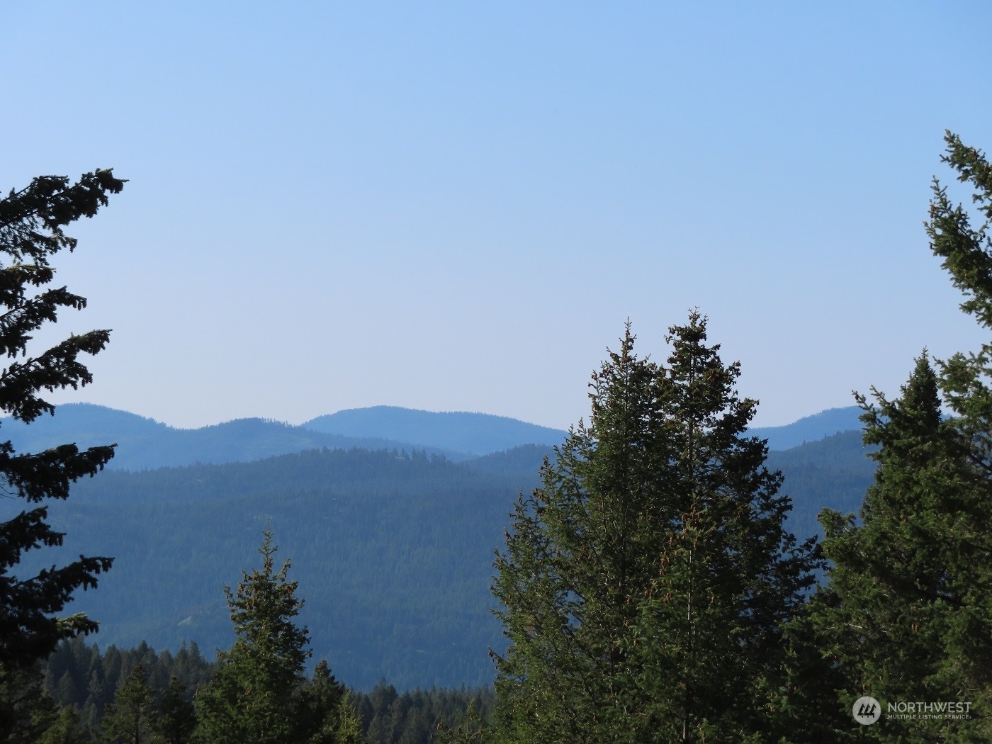 383 Pontiac Ridge Road Oroville, WA 98844 - Photo 3 of 32 a view of a lake with a mountain in the background