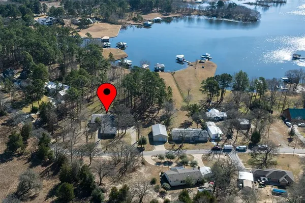 an aerial view of a house with a lake view