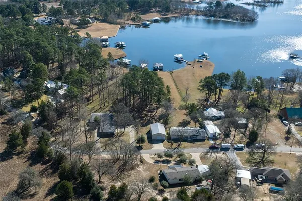an aerial view of a house with a lake view