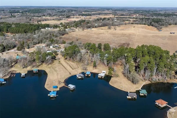 a view of a patio with chairs next to a lake