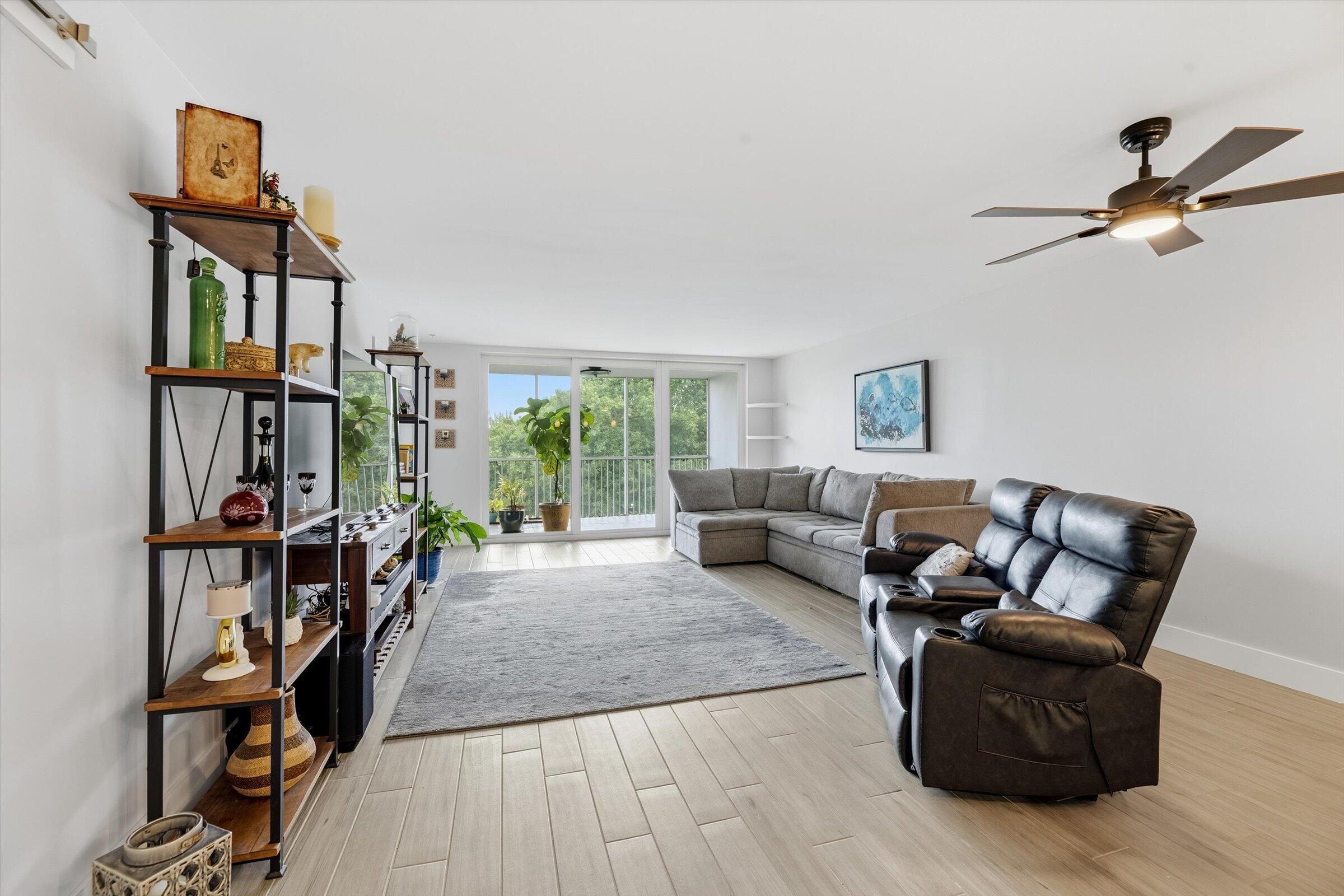 2600 South Course Drive, Unit 610 Pompano Beach, FL 33069 - Photo 12 of 33 a living room with furniture a flat screen tv and a window