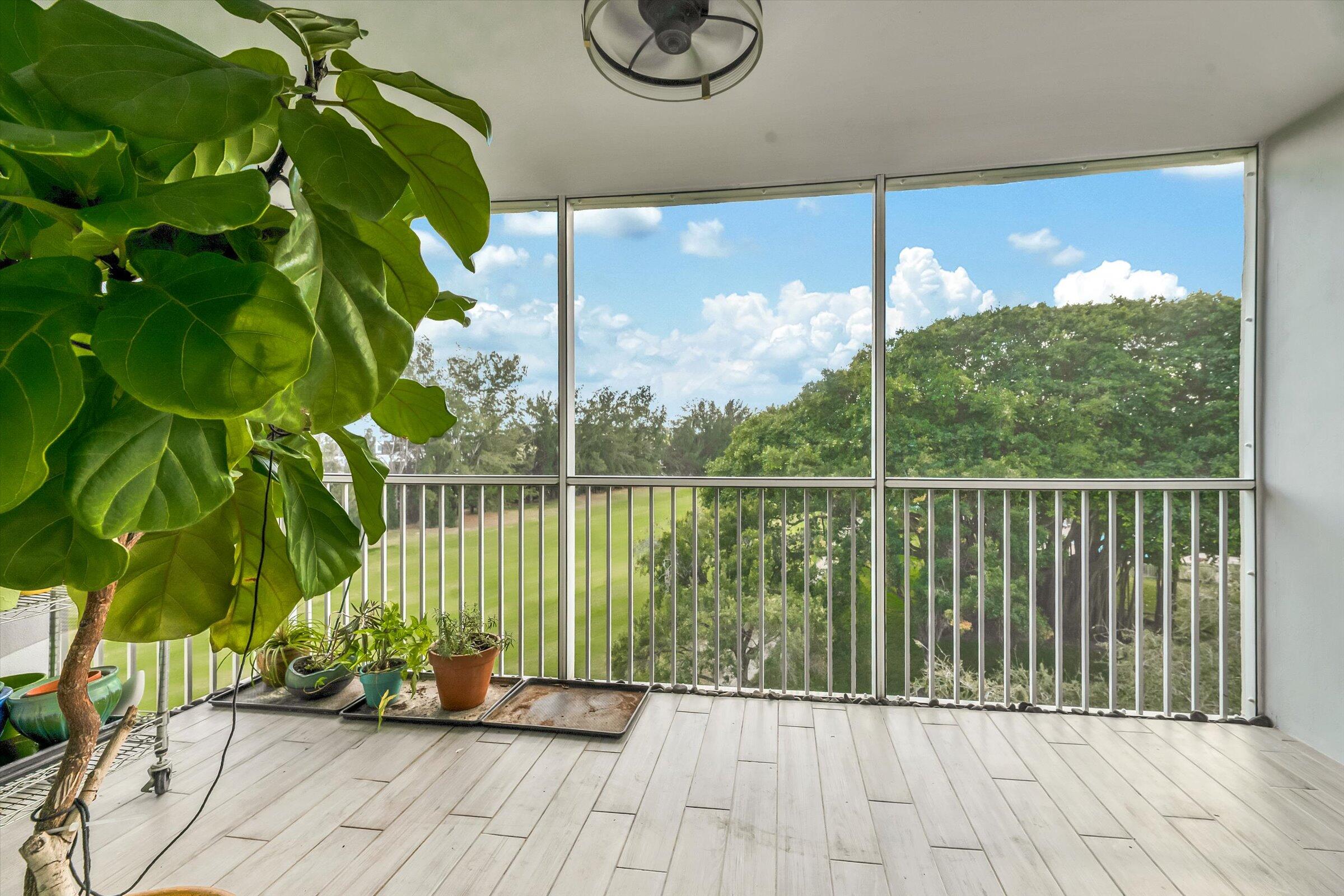 2600 South Course Drive, Unit 610 Pompano Beach, FL 33069 - Photo 16 of 33 a view of balcony with floor to ceiling window and wooden floor