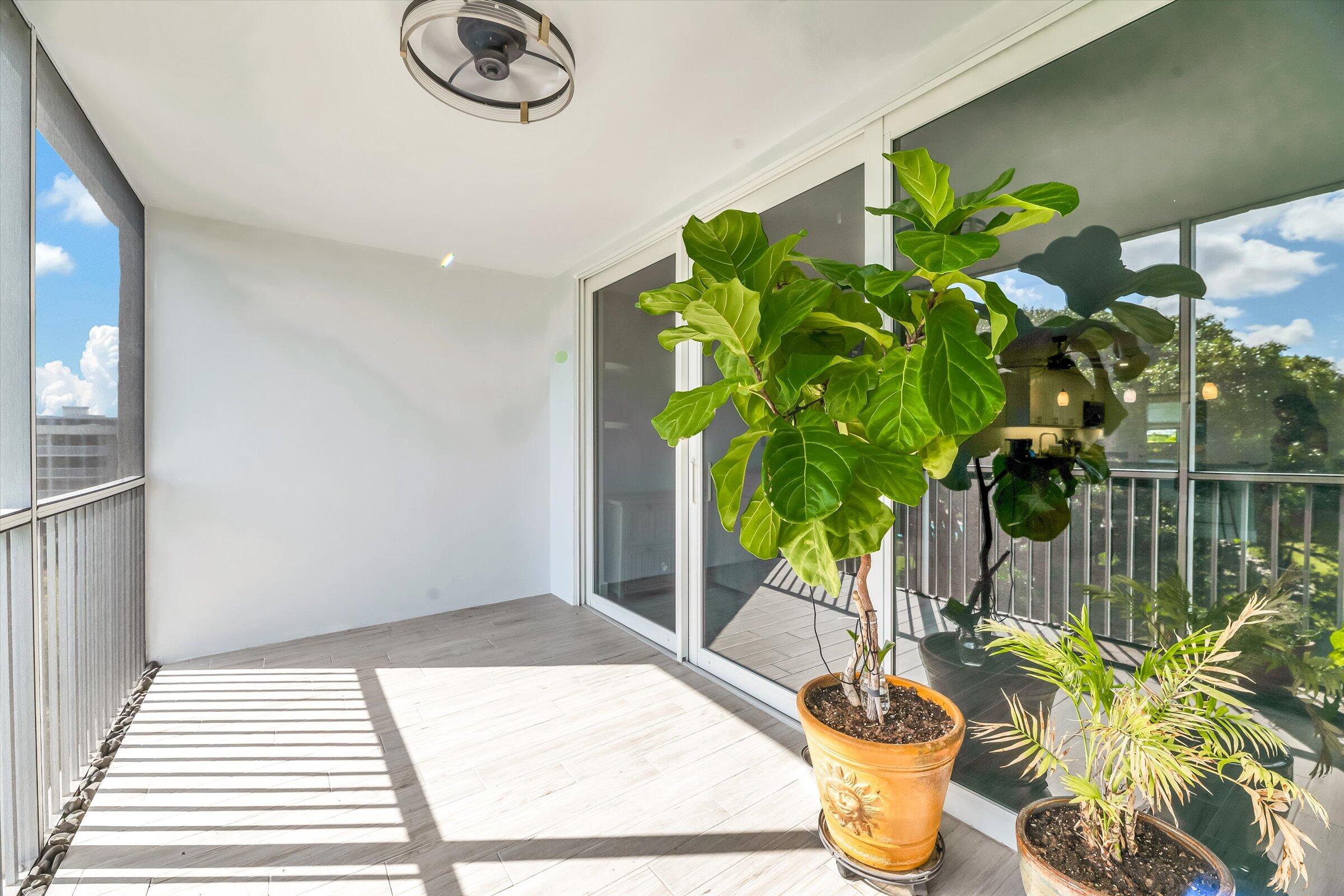 2600 South Course Drive, Unit 610 Pompano Beach, FL 33069 - Photo 18 of 33 a vase of flowers besides of a table with six mirrors