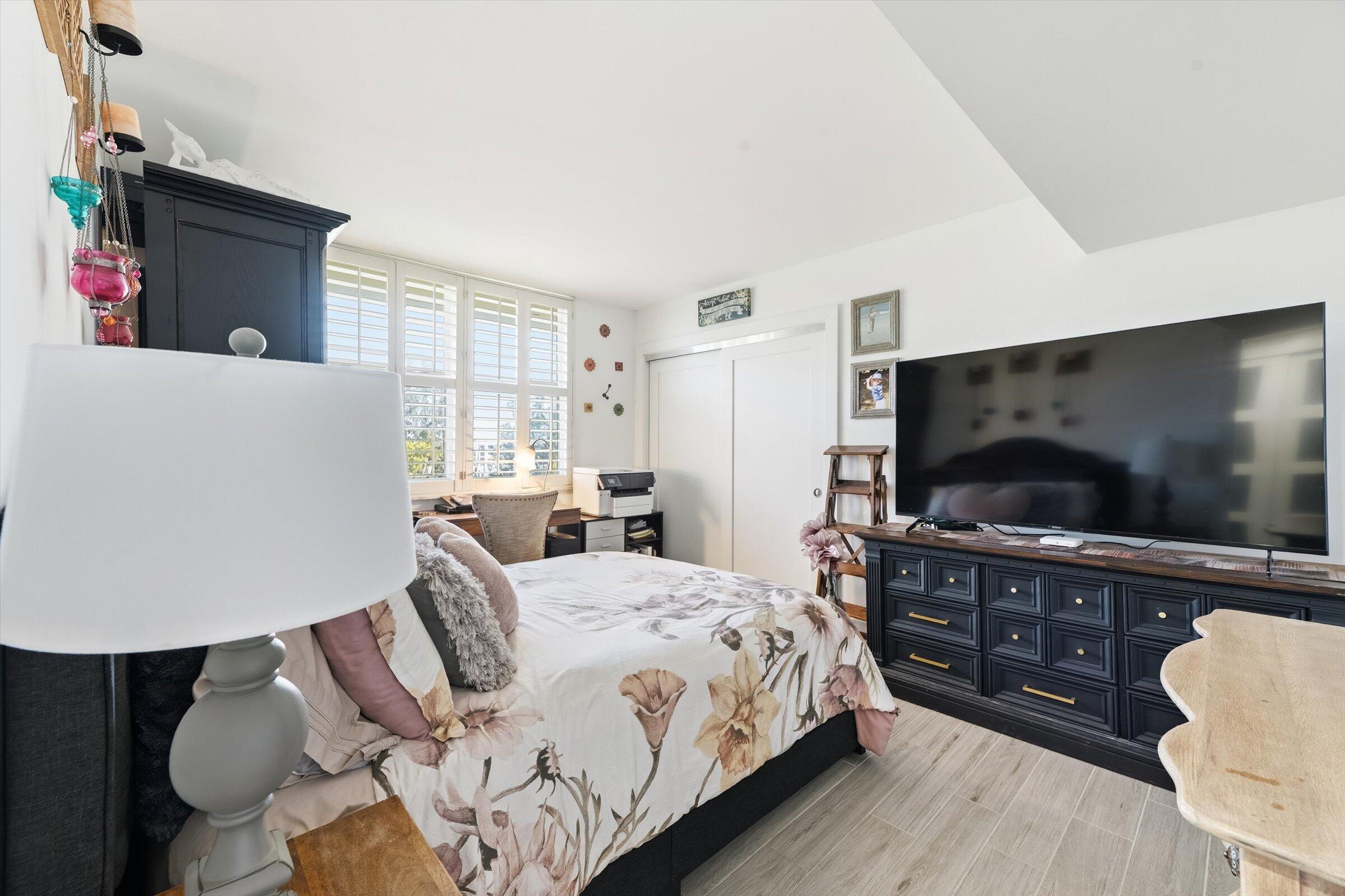 2600 South Course Drive, Unit 610 Pompano Beach, FL 33069 - Photo 19 of 33 a bedroom with a bed and a flat screen tv