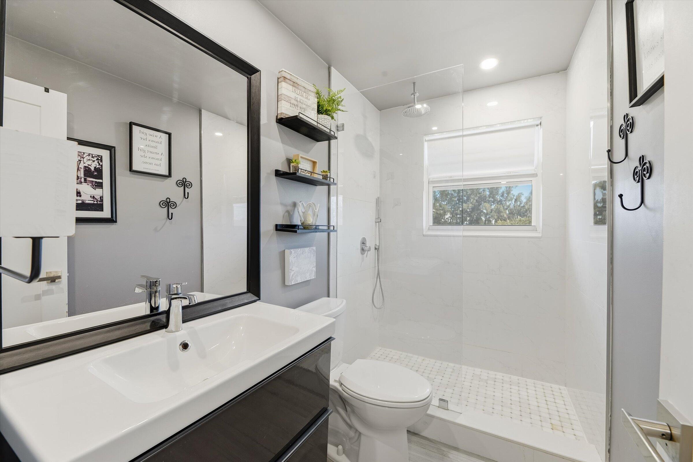 2600 South Course Drive, Unit 610 Pompano Beach, FL 33069 - Photo 21 of 33 a bathroom with a sink mirror toilet and shower