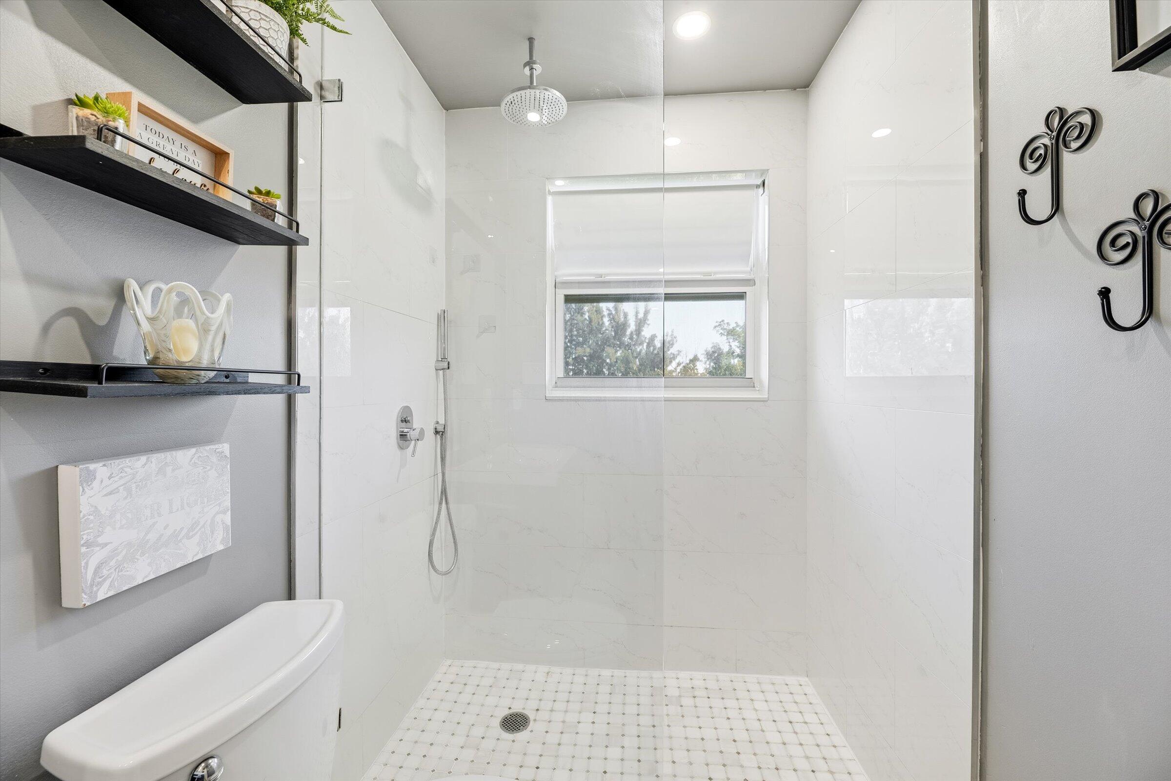 2600 South Course Drive, Unit 610 Pompano Beach, FL 33069 - Photo 22 of 33 a bathroom with a shower toilet and sink