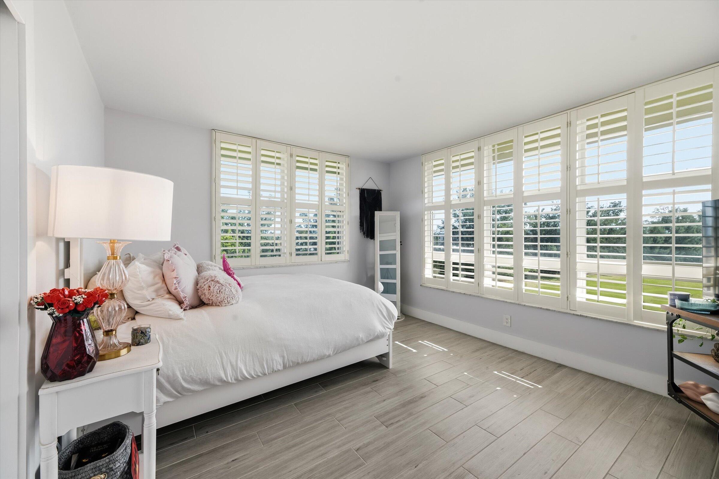 2600 South Course Drive, Unit 610 Pompano Beach, FL 33069 - Photo 24 of 33 a bed room with a bed and a large window