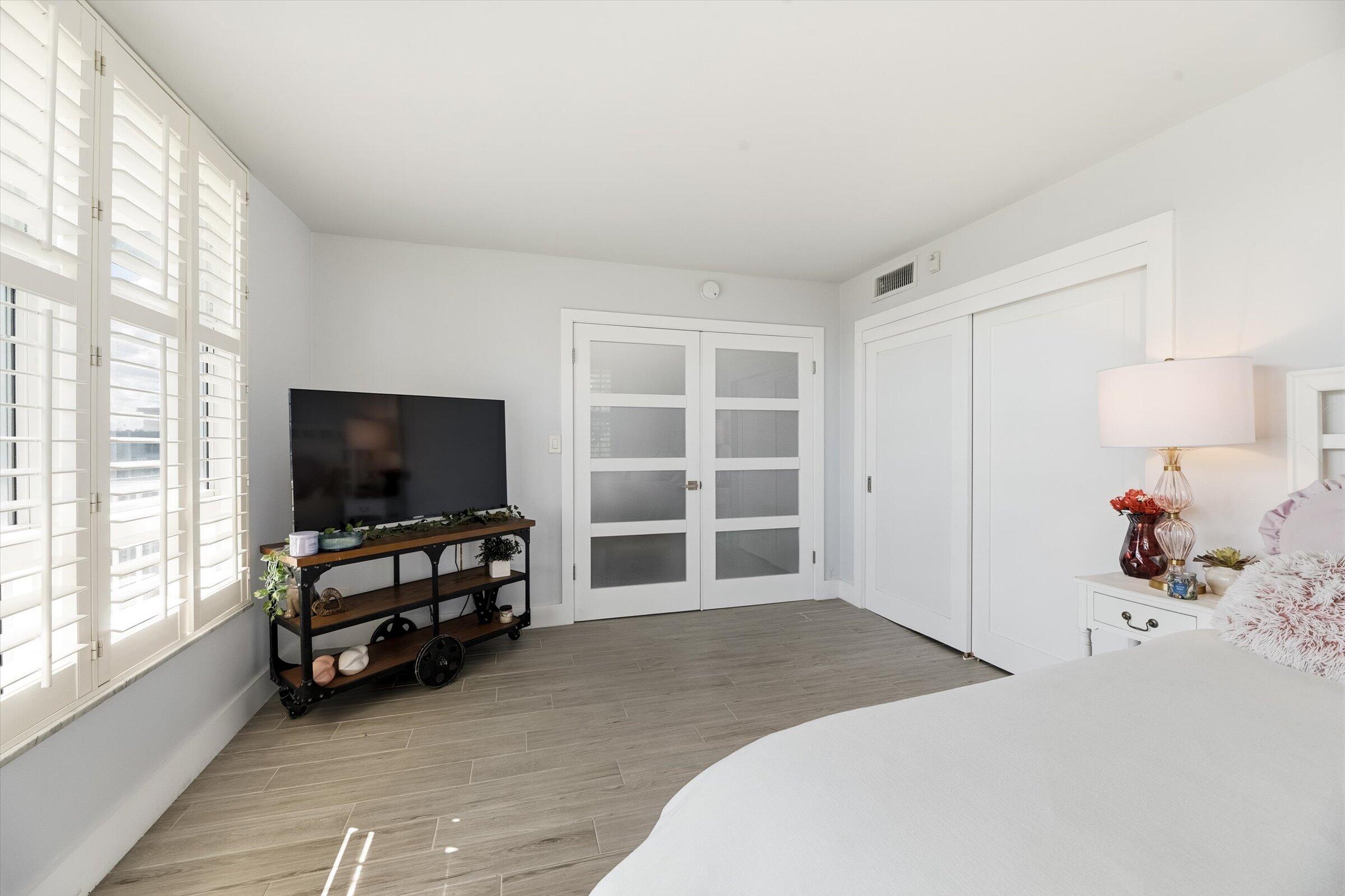 2600 South Course Drive, Unit 610 Pompano Beach, FL 33069 - Photo 26 of 33 a bedroom with closet and flat screen tv