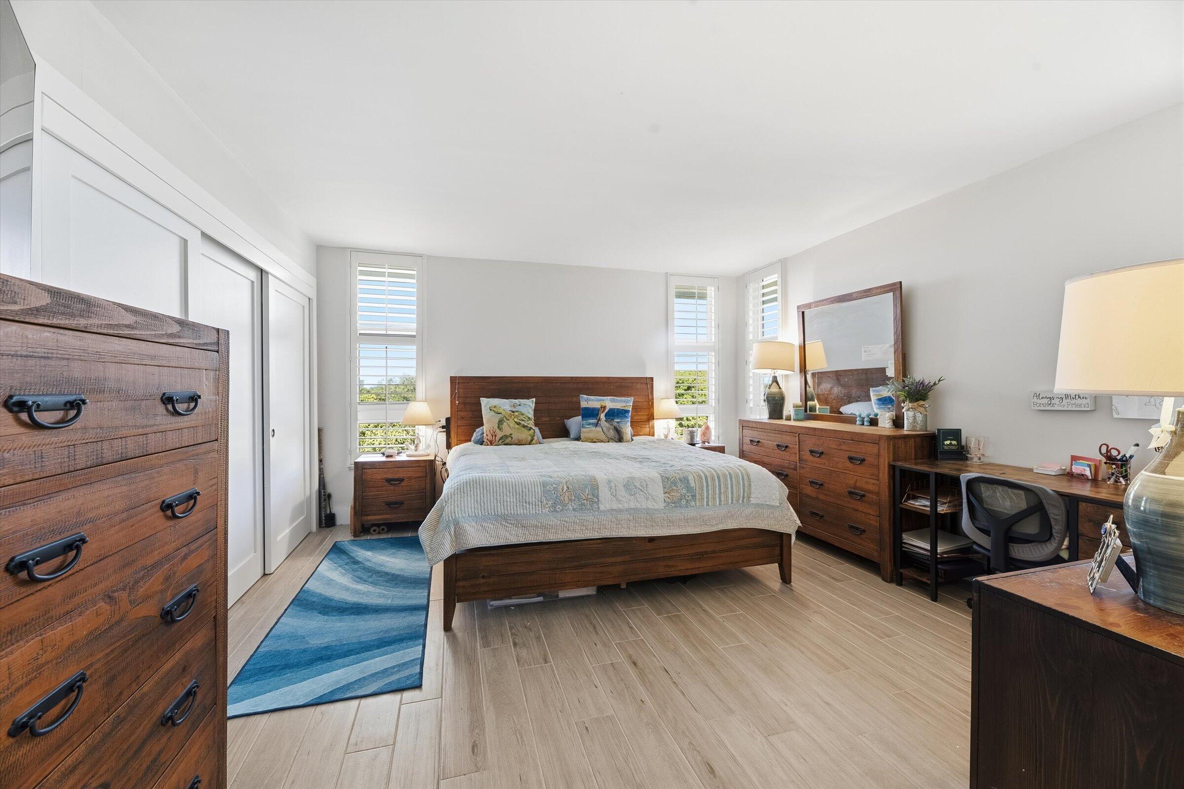 2600 South Course Drive, Unit 610 Pompano Beach, FL 33069 - Photo 27 of 33 a bedroom with a bed and wooden floor