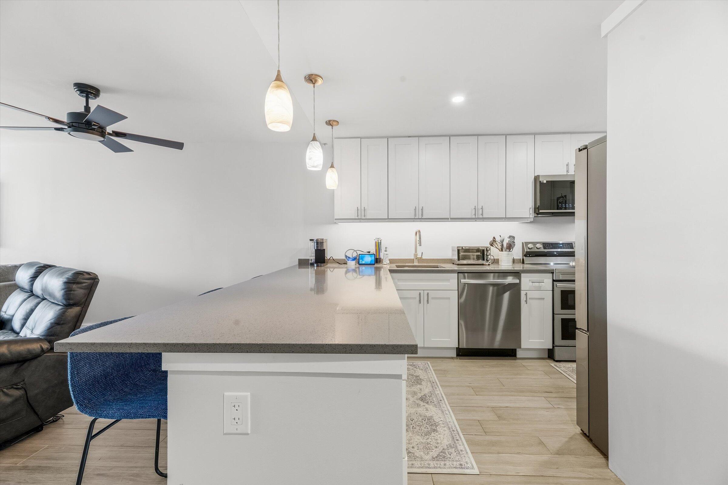 2600 South Course Drive, Unit 610 Pompano Beach, FL 33069 - Photo 6 of 33 a kitchen with a sink a stove and cabinets
