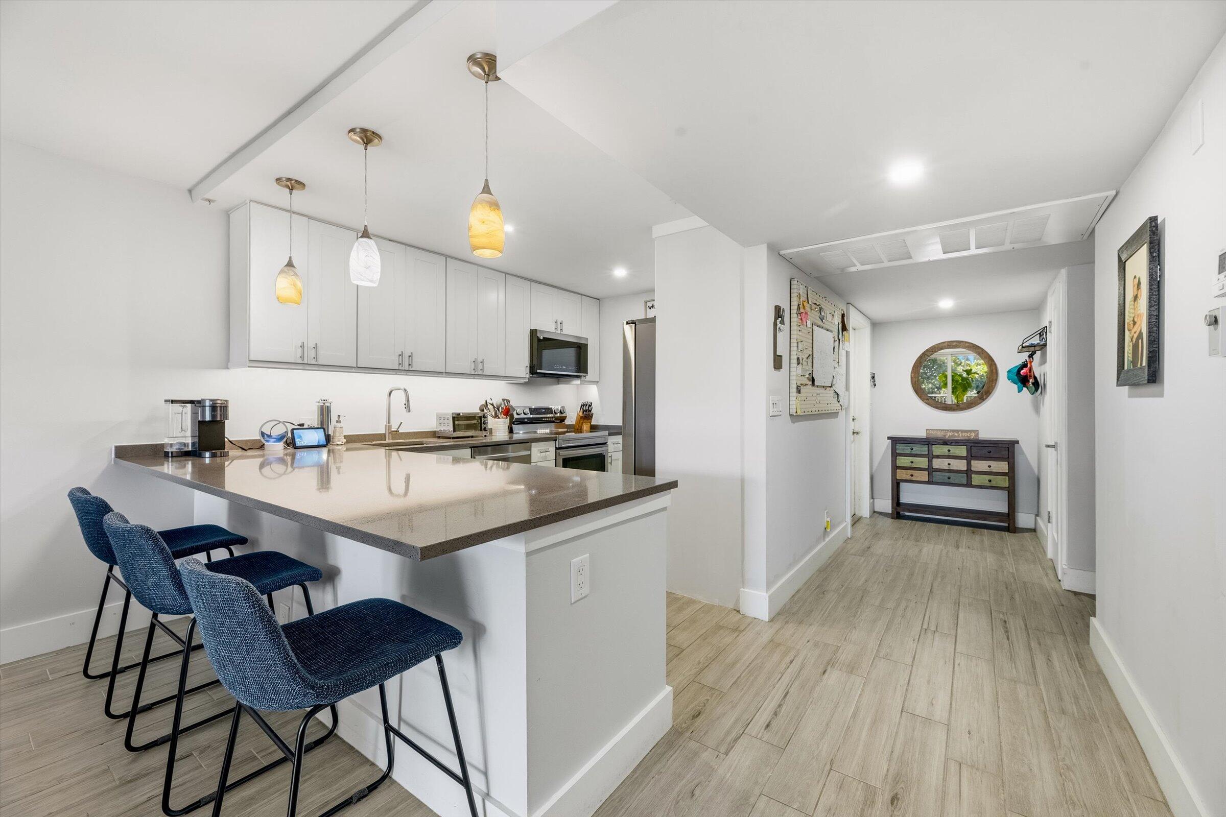 2600 South Course Drive, Unit 610 Pompano Beach, FL 33069 - Photo 7 of 33 a kitchen with granite countertop a sink cabinets and wooden floor