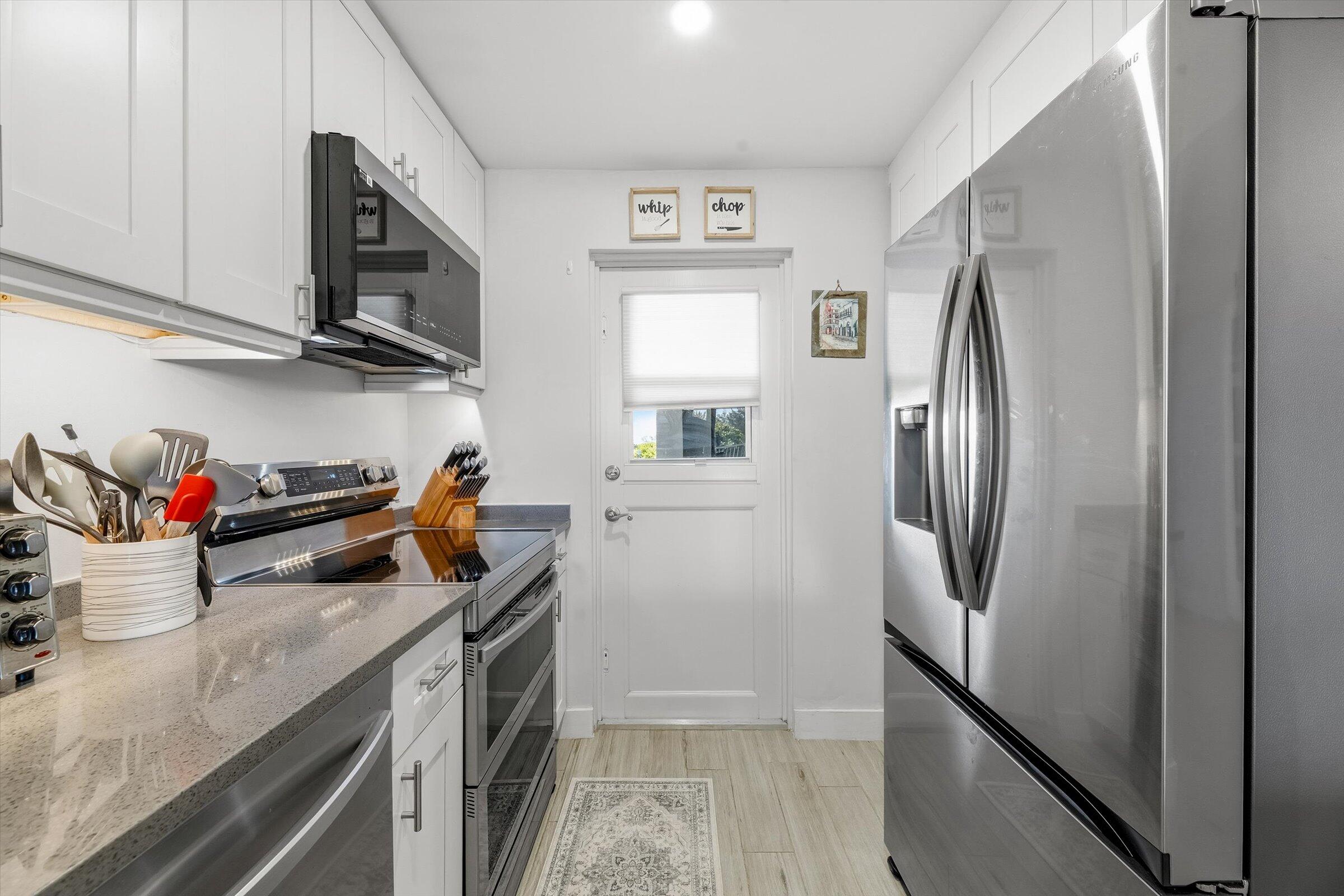 2600 South Course Drive, Unit 610 Pompano Beach, FL 33069 - Photo 10 of 33 a kitchen with stainless steel appliances granite countertop a refrigerator and a sink