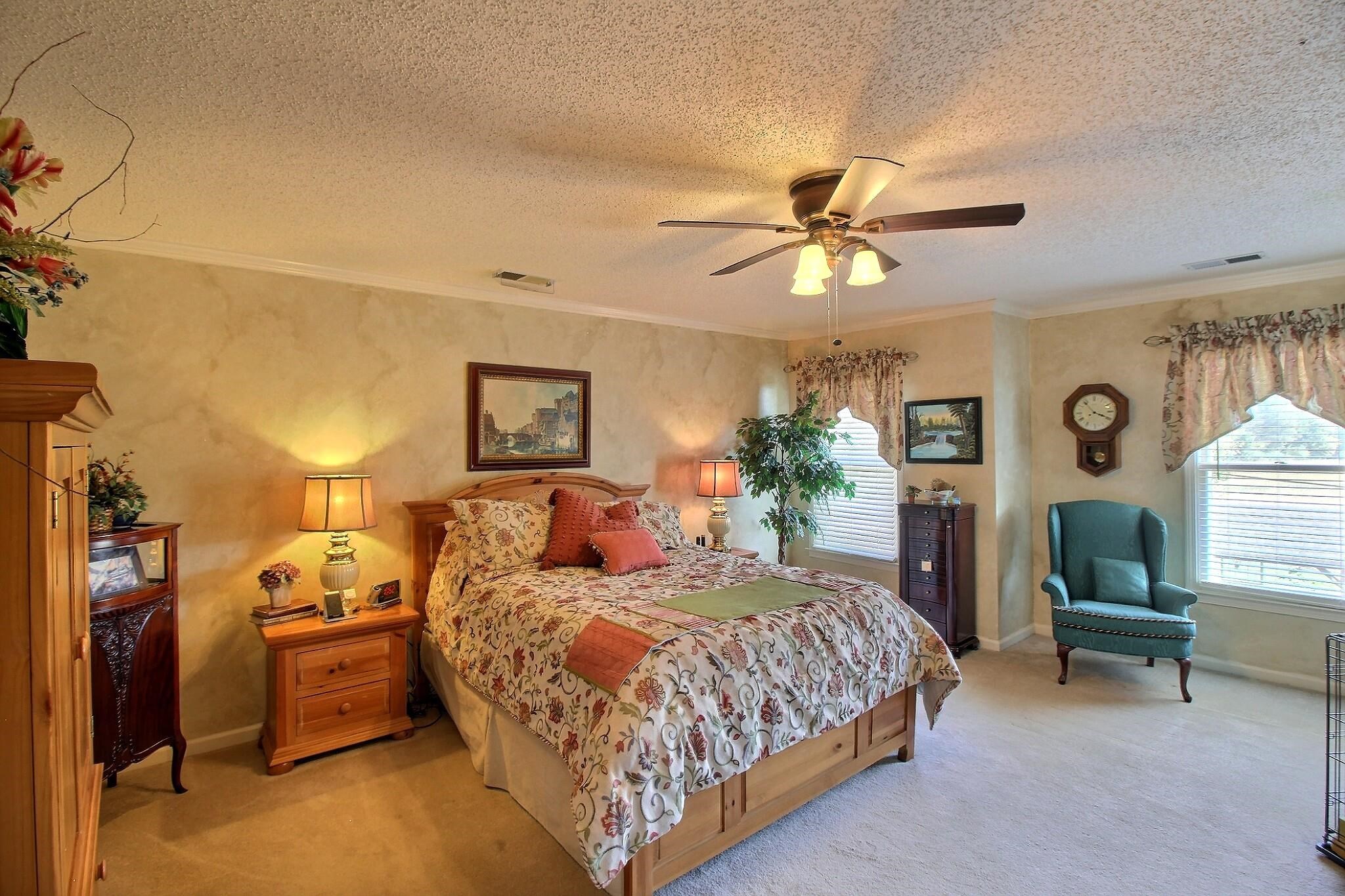 798 Early Earner Cove Collierville, TN 38017 - Photo 14 of 26 a spacious bedroom with a bed a chandelier and window