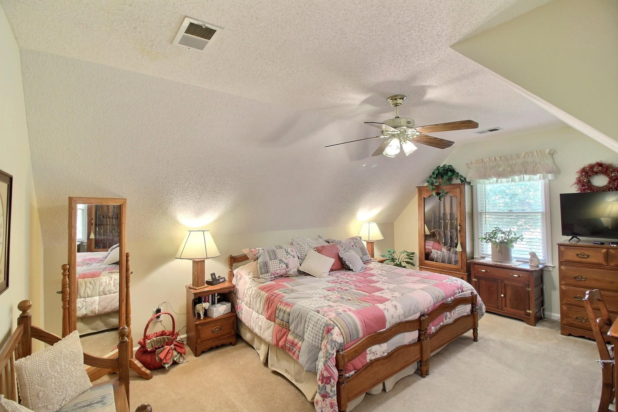 798 Early Earner Cove Collierville, TN 38017 - Photo 17 of 26 a bedroom with a bed and a flat tv screen on dresser
