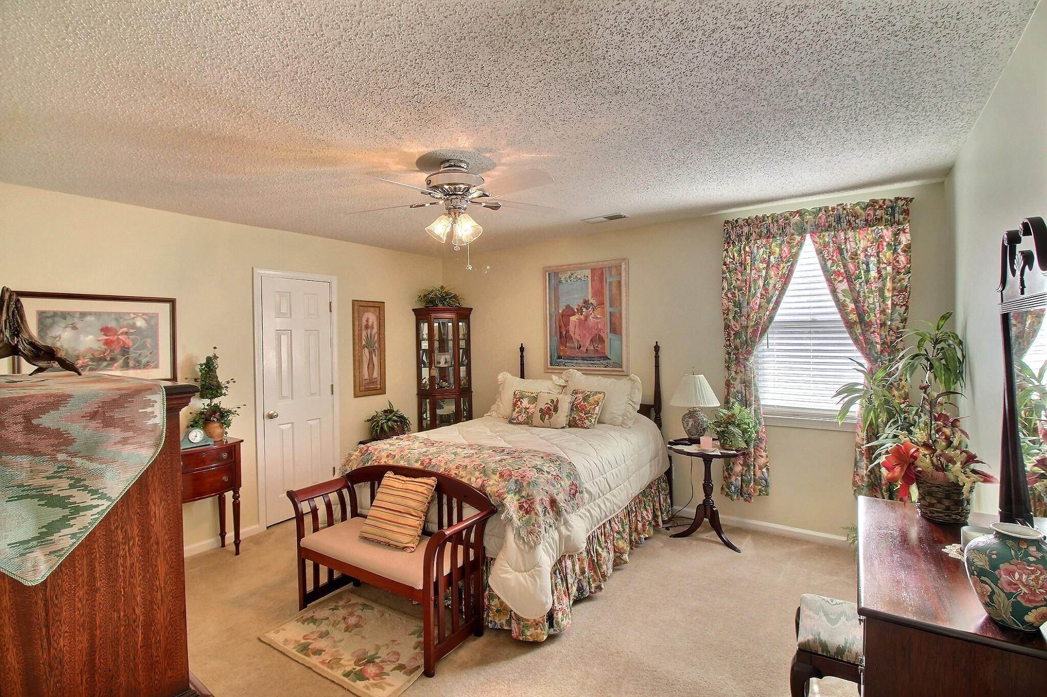 798 Early Earner Cove Collierville, TN 38017 - Photo 19 of 26 a bedroom with a bed and a chandelier