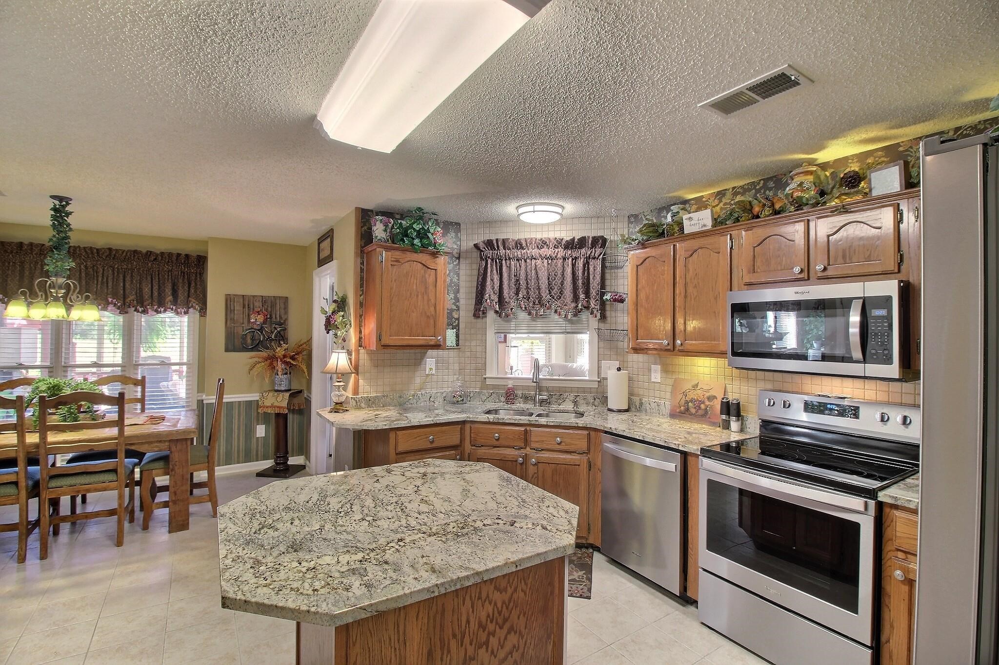 798 Early Earner Cove Collierville, TN 38017 - Photo 9 of 26 a kitchen with stainless steel appliances granite countertop a sink and cabinets