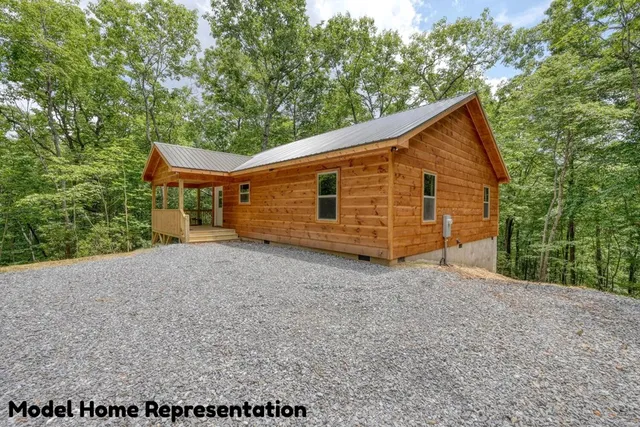 a view of a livingroom with a fireplace and window
