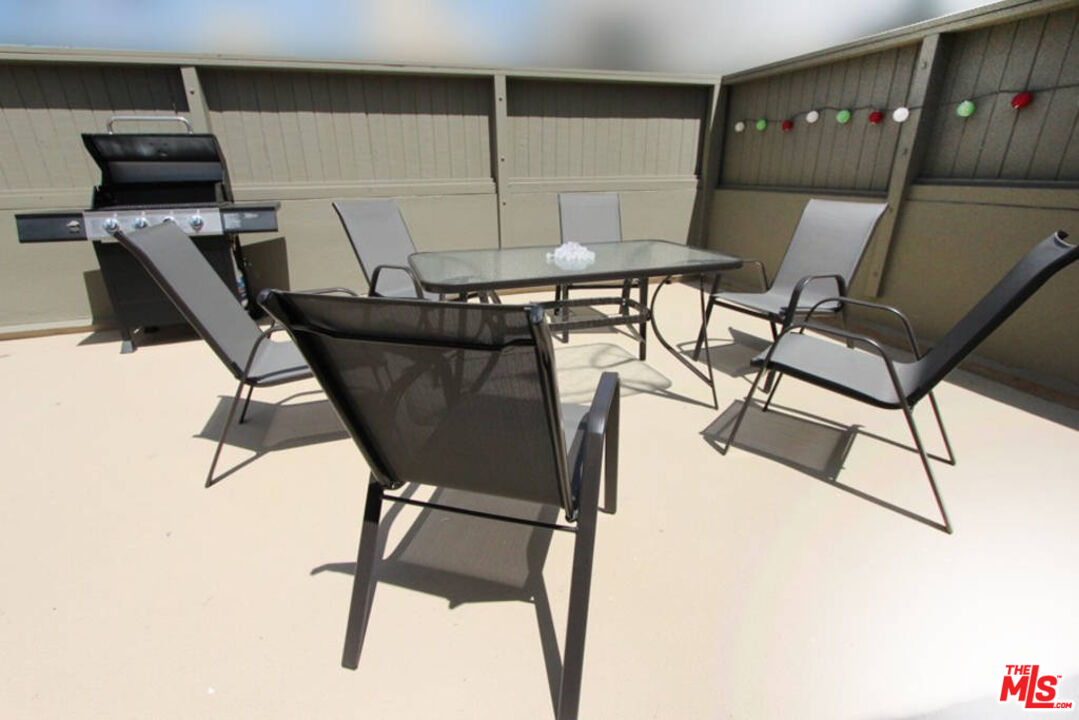 a view of a dining room with furniture and a kitchen