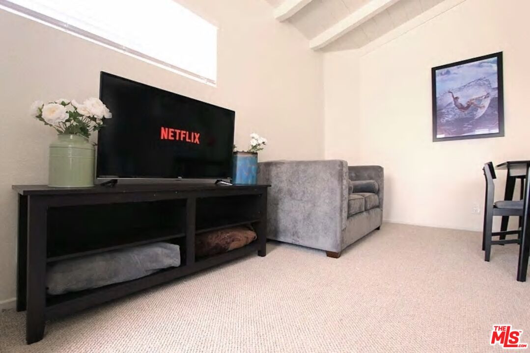 3005 Ocean Front Walk, Unit E Venice, CA 90291 - Photo 2 of 6 a living room with furniture and a flat screen tv