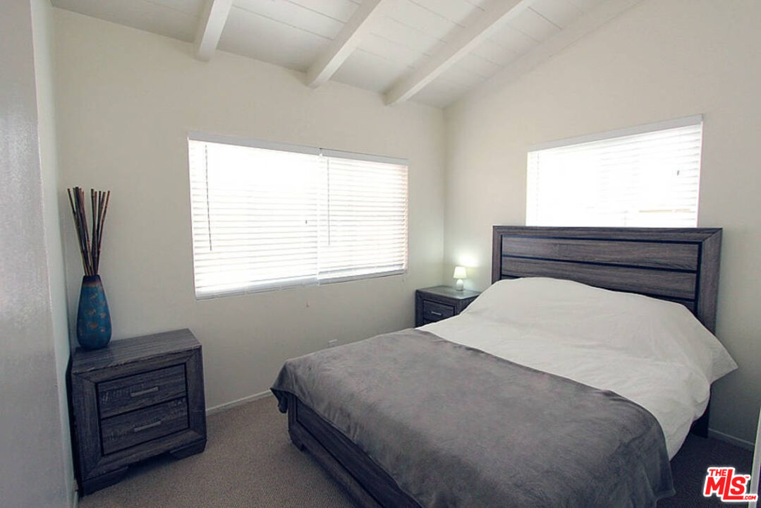 3005 Ocean Front Walk, Unit E Venice, CA 90291 - Photo 4 of 6 a bedroom with a bed and window