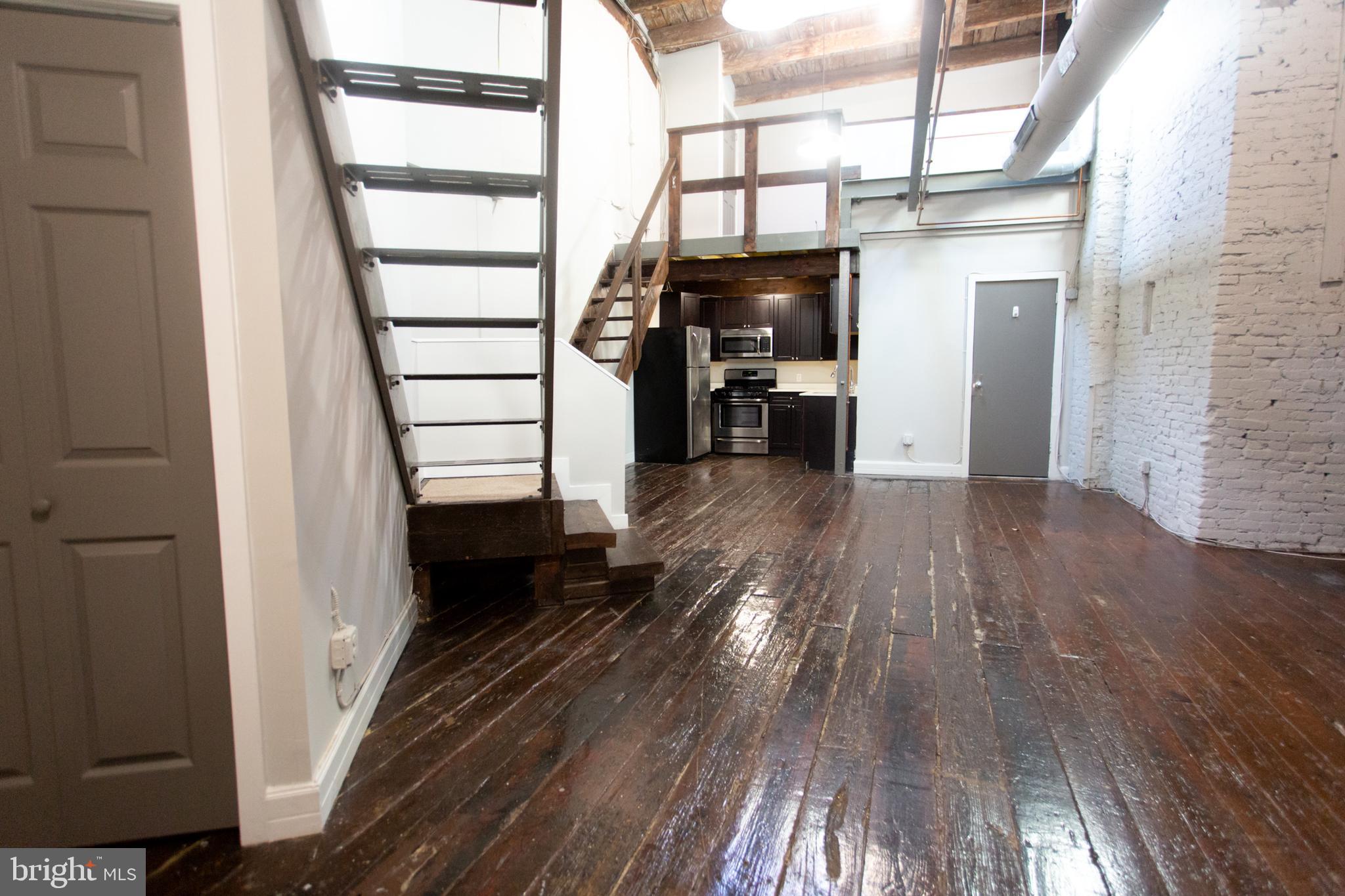715 South 3rd Street, Unit 204 Philadelphia, PA 19147 - Photo 2 of 28 a view of hallway with wooden floor and furniture