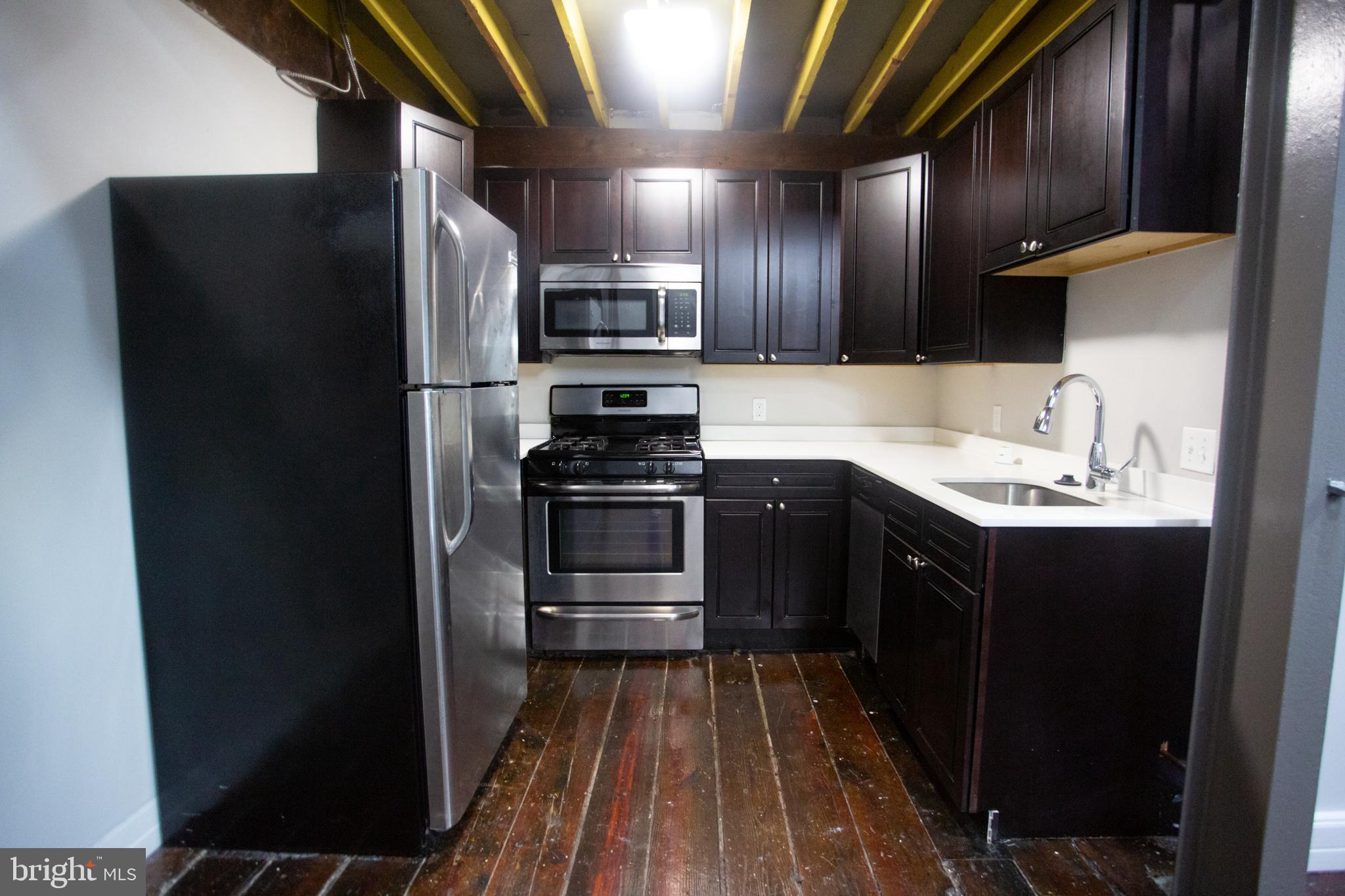 715 South 3rd Street, Unit 204 Philadelphia, PA 19147 - Photo 8 of 28 a kitchen with stainless steel appliances granite countertop a refrigerator and a sink