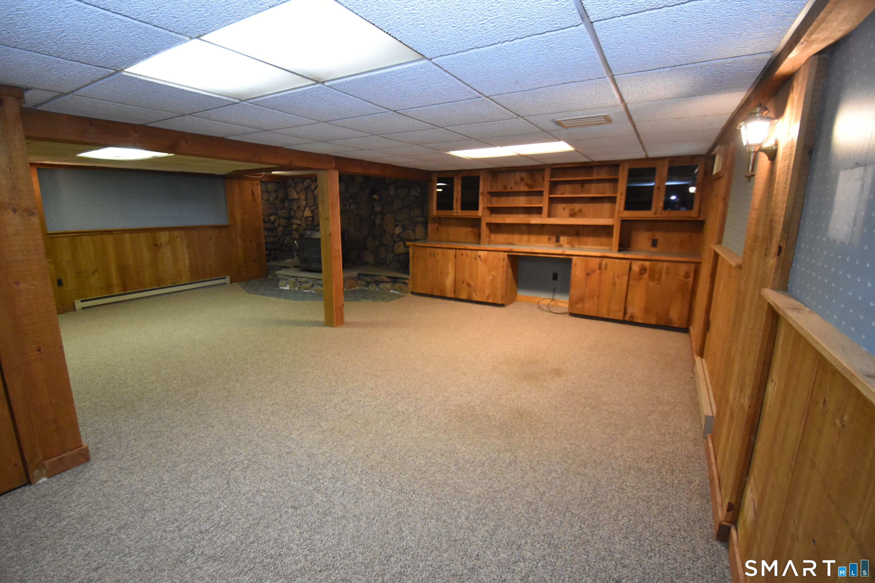 77 Winthrop Road Manchester, CT 06040 - Photo 12 of 17 Lower Level Rec Room with Wood Stove