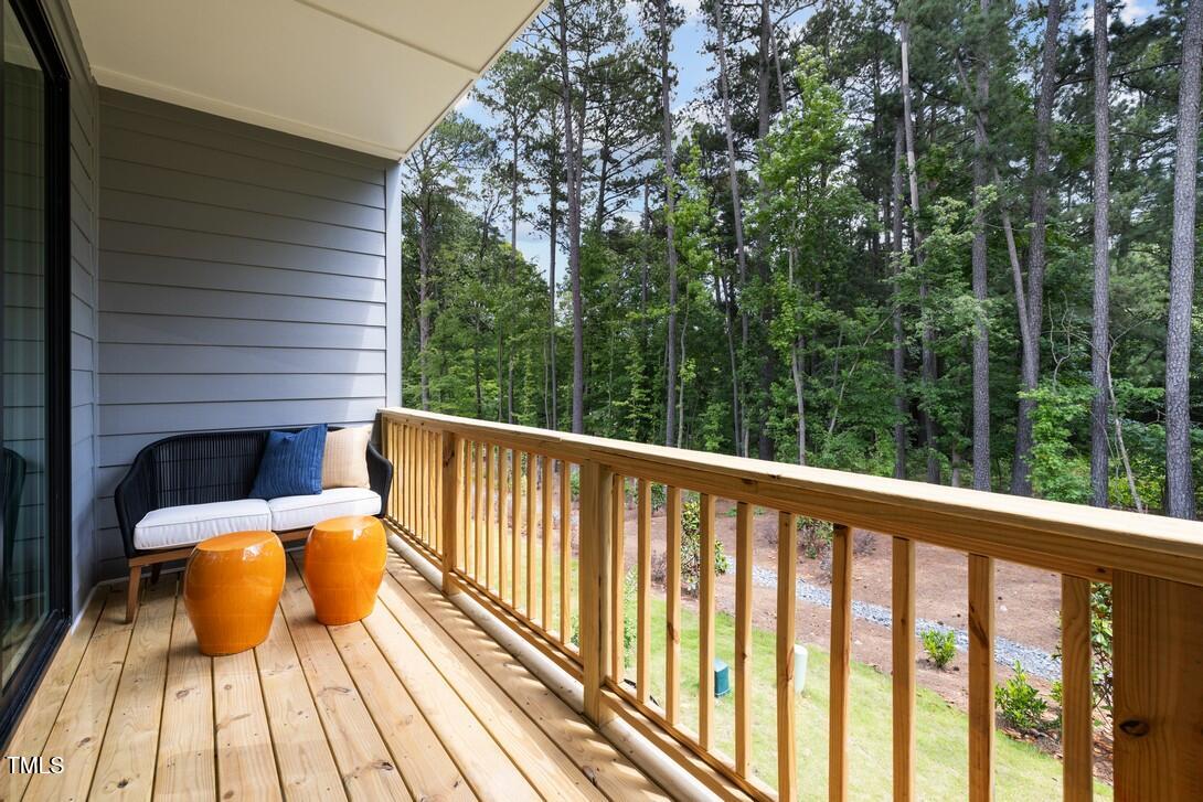 4713 Mint Leaf Lane Raleigh, NC 27612 - Photo 26 of 43 a balcony with wooden floor and iron fence