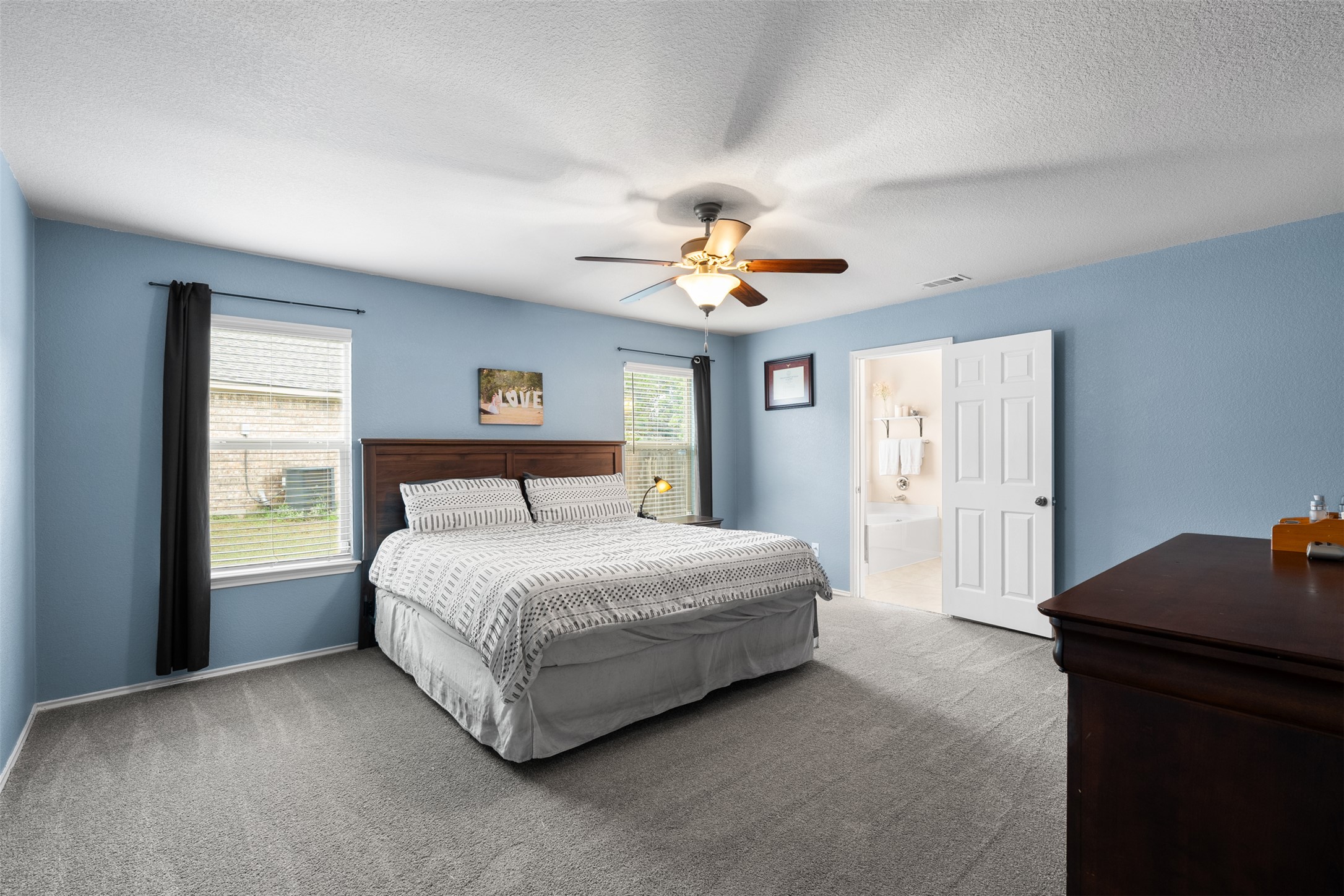 137 Barn Owl Loop Leander, TX 78641 - Photo 20 of 36 a spacious bedroom with a bed and a window