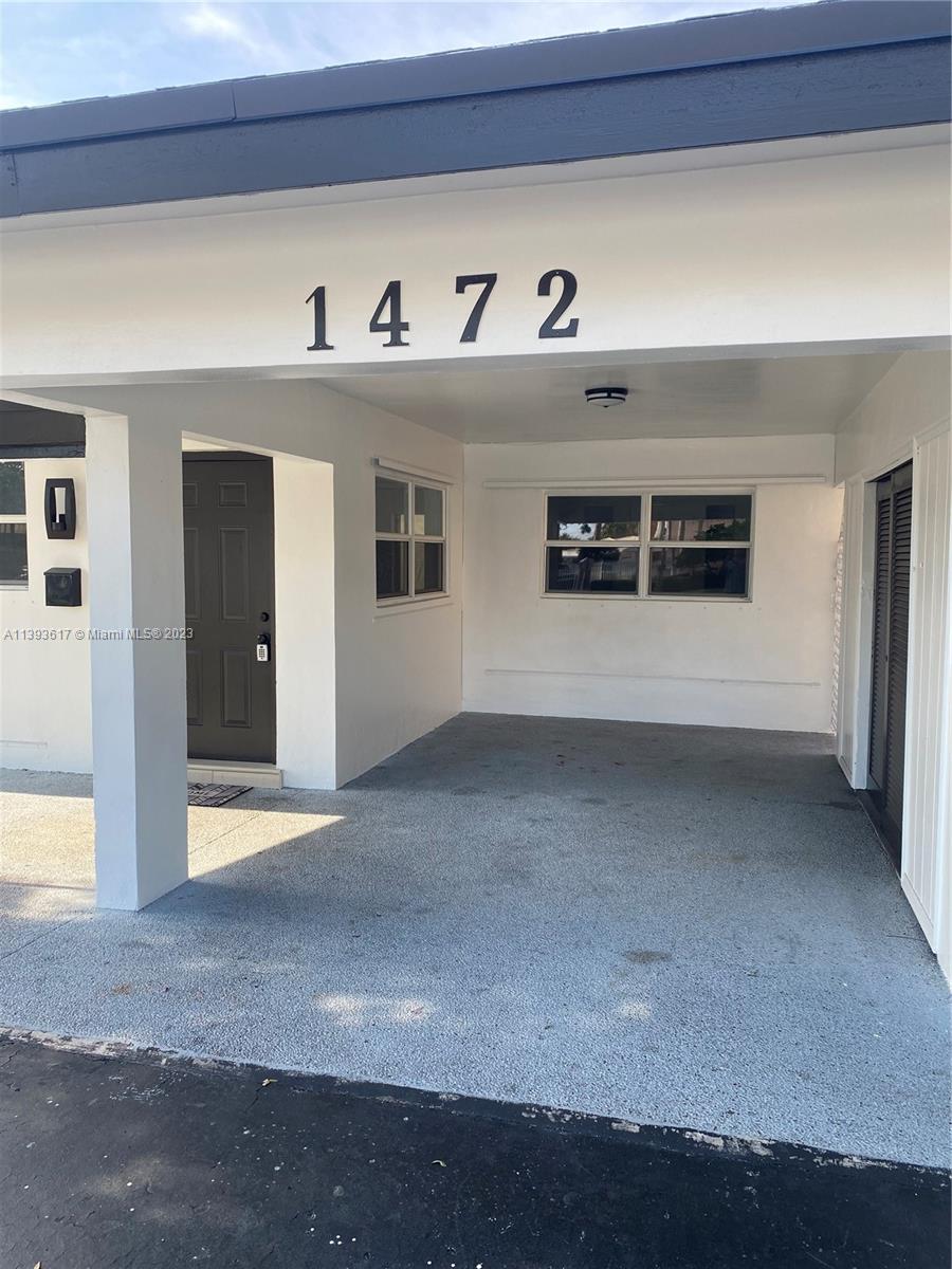 1472 Northeast 62nd Street, Unit 1472 Fort Lauderdale, FL 33334 - Photo 1 of 19 a view of a hallway with workspace