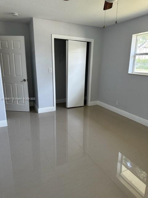 1472 Northeast 62nd Street, Unit 1472 Fort Lauderdale, FL 33334 - Photo 11 of 19 an empty room with windows and closet