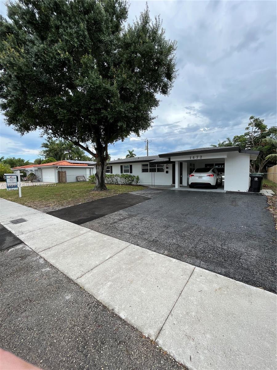 1472 Northeast 62nd Street, Unit 1472 Fort Lauderdale, FL 33334 - Photo 18 of 19 a view of house with outdoor space and street view