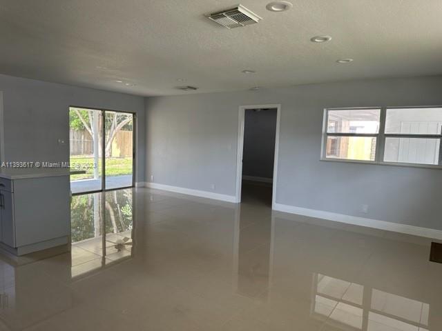 1472 Northeast 62nd Street, Unit 1472 Fort Lauderdale, FL 33334 - Photo 4 of 19 an empty room with windows