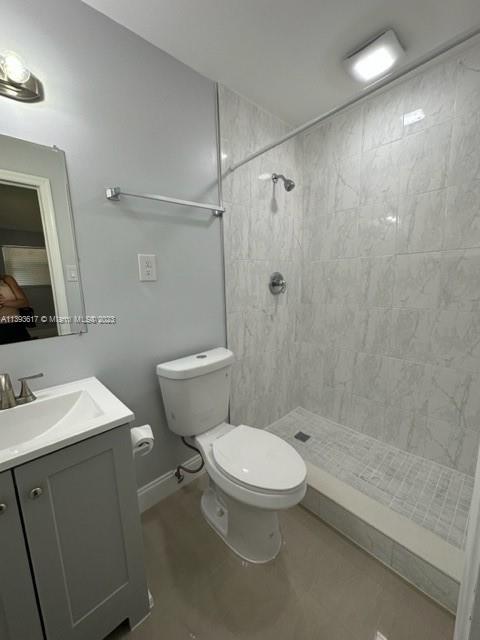 1472 Northeast 62nd Street, Unit 1472 Fort Lauderdale, FL 33334 - Photo 5 of 19 a bathroom with a toilet a sink a mirror and shower