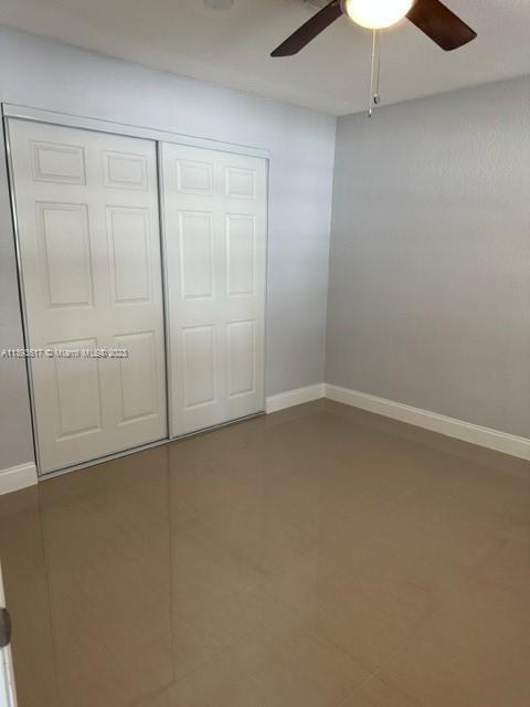 1472 Northeast 62nd Street, Unit 1472 Fort Lauderdale, FL 33334 - Photo 9 of 19 an empty room with a fan