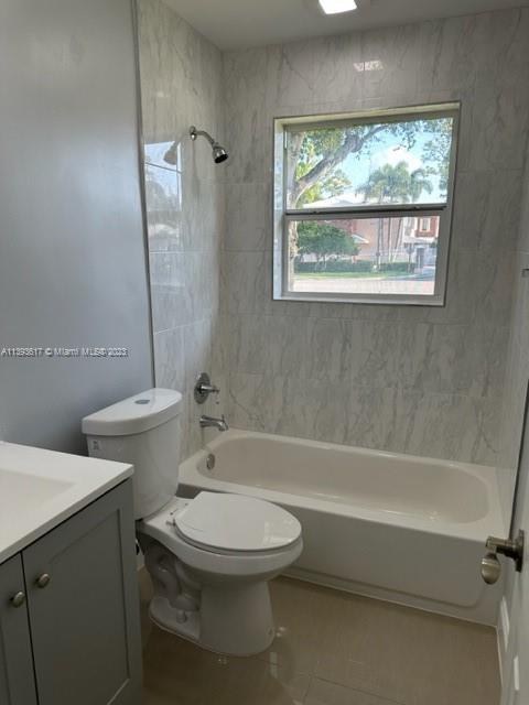 1472 Northeast 62nd Street, Unit 1472 Fort Lauderdale, FL 33334 - Photo 10 of 19 a bathroom with a toilet a sink and bathtub