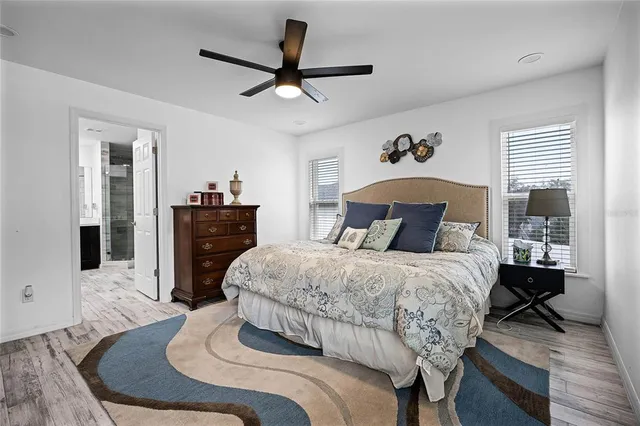 a bedroom with a bed and wooden floor