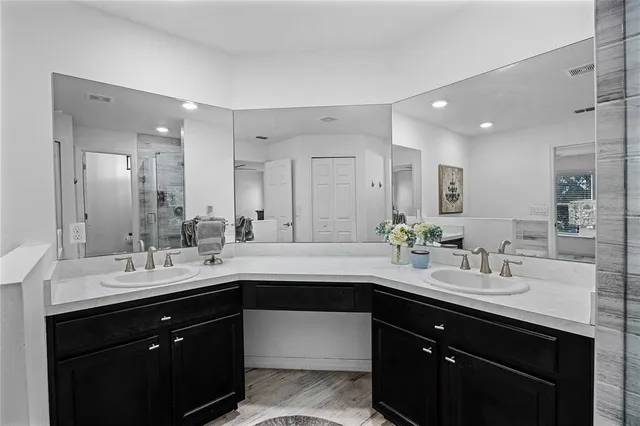 a bathroom with a sink double vanity and a mirror