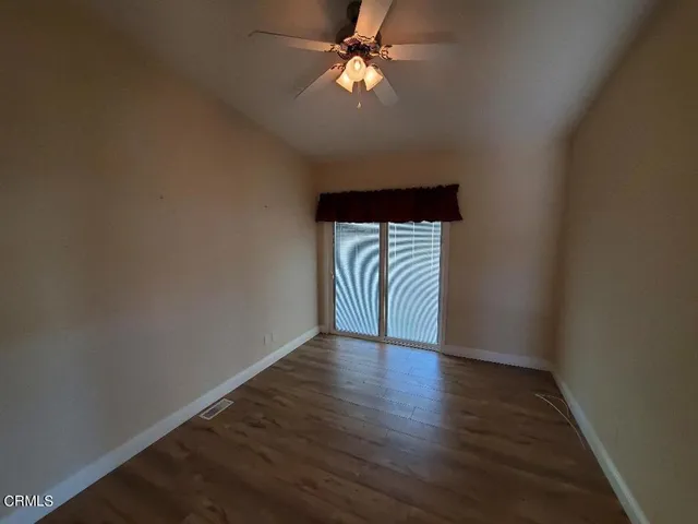 a view of a bedroom with wooden floor