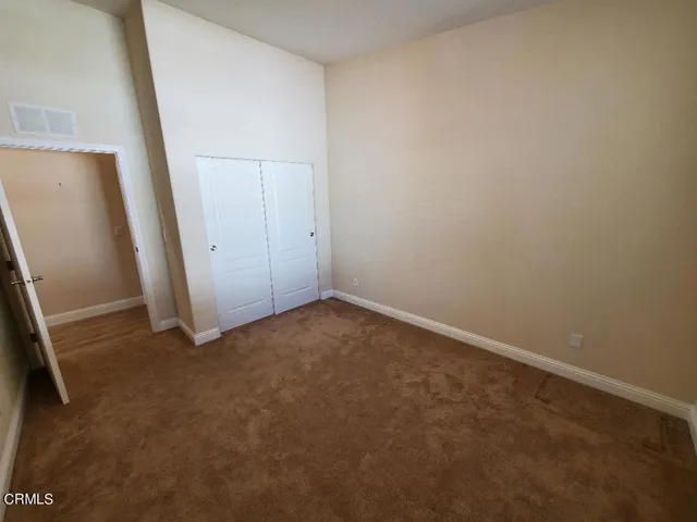 a bathroom with a granite countertop sink a mirror and shower
