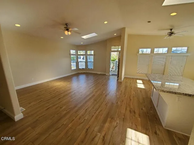 a kitchen with kitchen island a sink stove and wooden floor