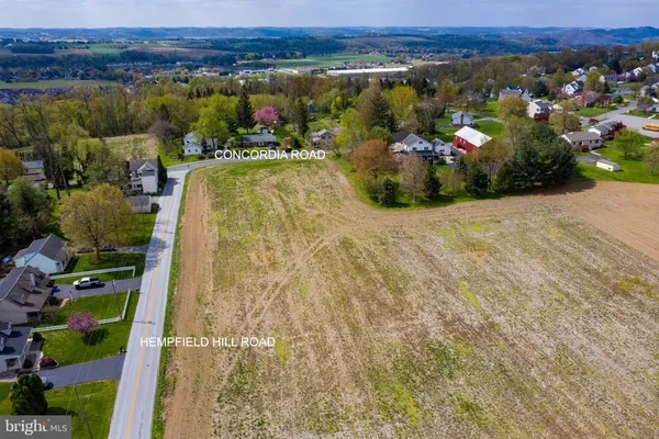 a view of a field with an ocean view