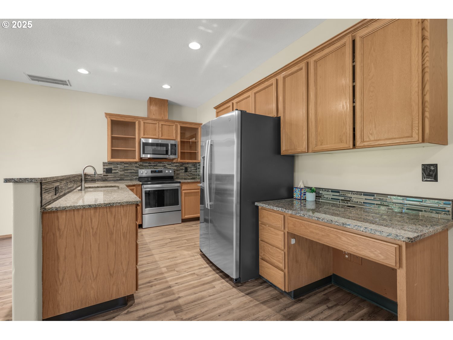 1512 Southwest 5th Street Battle Ground, WA 98604 - Photo 8 of 25 a kitchen with kitchen island stainless steel appliances a stove refrigerator sink and cabinets