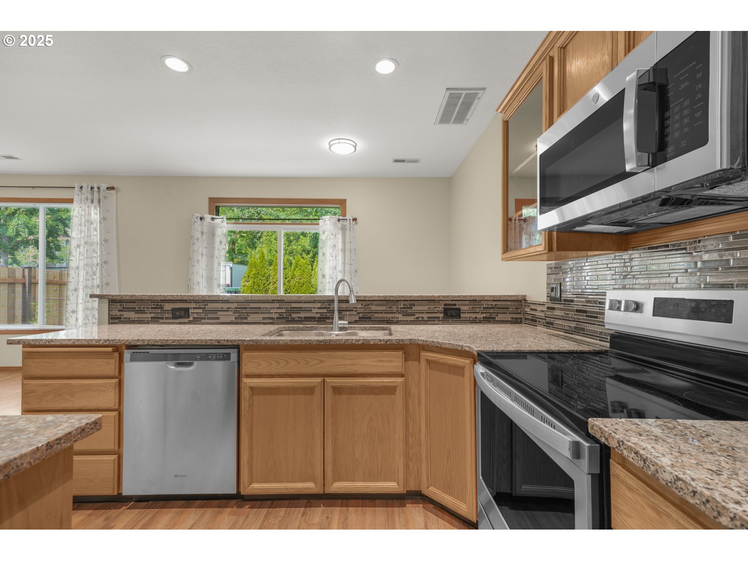 1512 Southwest 5th Street Battle Ground, WA 98604 - Photo 10 of 25 a kitchen with stainless steel appliances granite countertop a sink stove and microwave