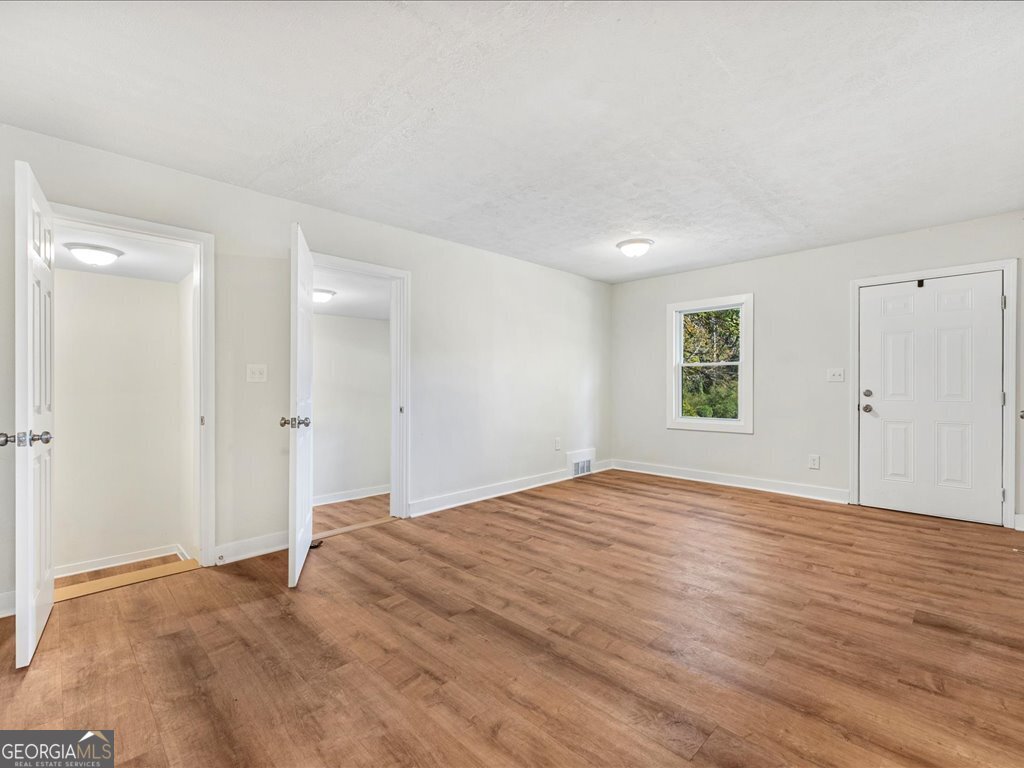2905 Gresham Rd S East Atlanta, GA 30316 - Photo 12 of 27 a view of an empty room with wooden floor and a window