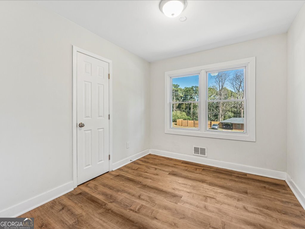 2905 Gresham Rd S East Atlanta, GA 30316 - Photo 15 of 27 wooden floor in an empty room with a window