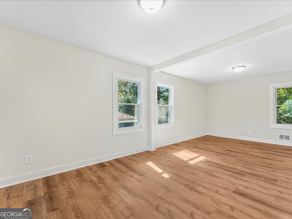 2905 Gresham Rd S East Atlanta, GA 30316 - Photo 18 of 27 a view of an empty room with wooden floor and a window